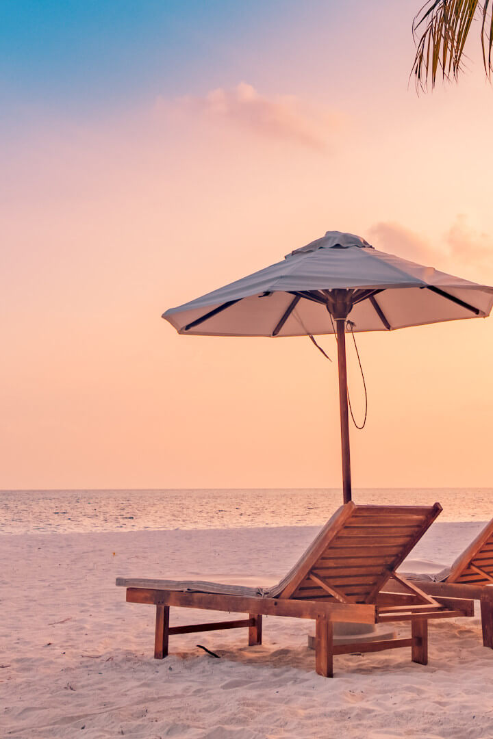 empty beach chairs and umbrella on beach