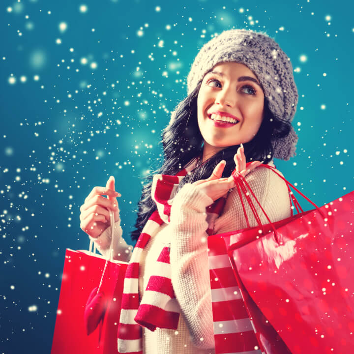 woman hold shopping bags with snowy background