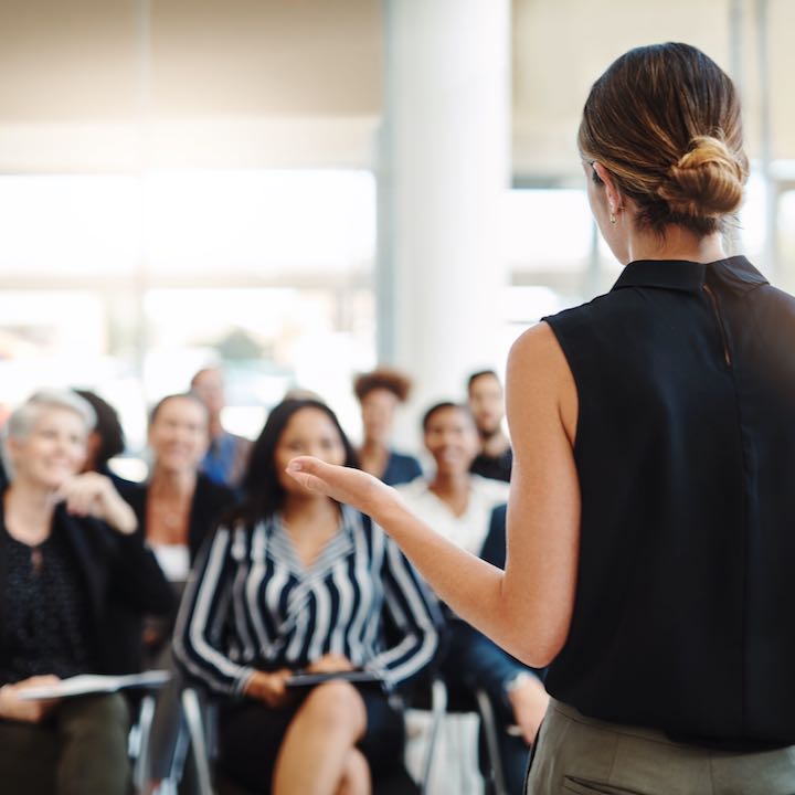 woman presenting to group of people